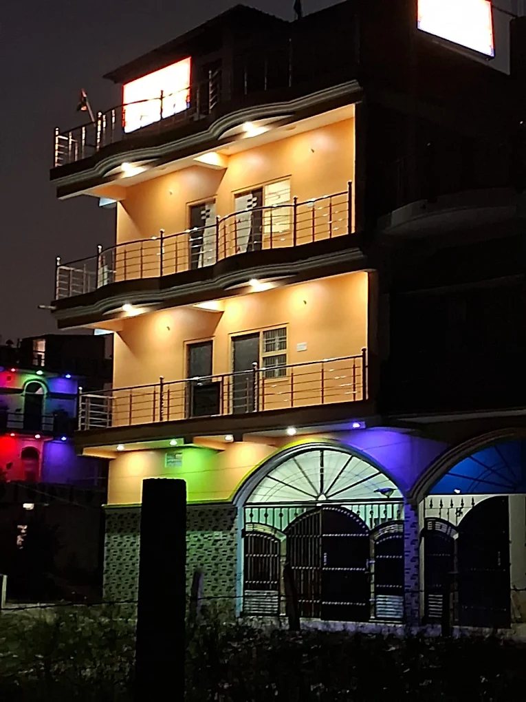 The exterior of Shiv Mansadhika Marriage and Banquet Hall illuminated at night