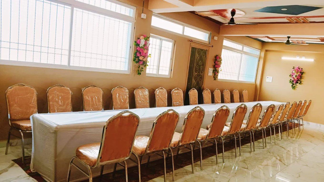 Dining tables and chairs photographed inside the Koilwar venue